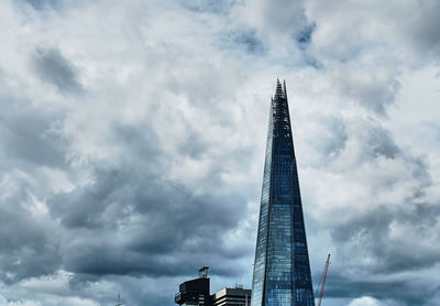 Low angle view of building against cloudy sky