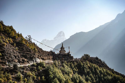 Scenic view of mountains against sky with stupa