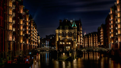 Illuminated buildings in city at night