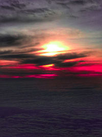 Scenic view of dramatic sky over sea during sunset