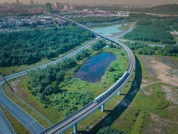 High angle view of road amidst trees in city