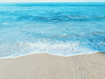 Scenic view of beach against blue sky