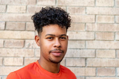 Portrait of young man against wall