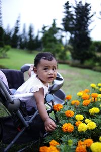 Full length of girl with flowers in park