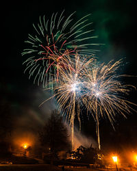 Low angle view of firework display at night