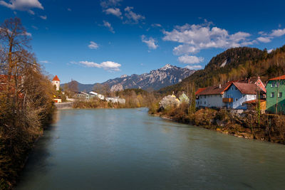 Scenic view of lake by buildings against sky