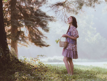 Full length of woman standing on field