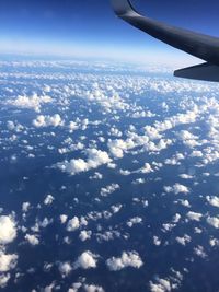 Aerial view of clouds over landscape seen from airplane