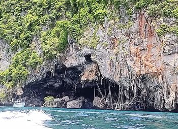 People on rock by sea