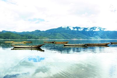 Scenic view of lake against cloudy sky