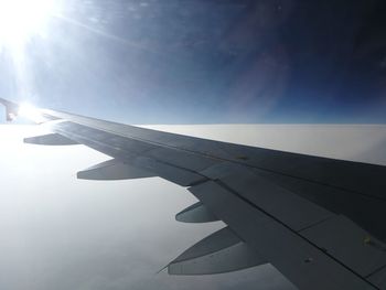 Airplane wing against sky