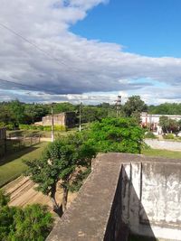 View of trees against cloudy sky