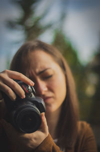 Portrait of woman photographing