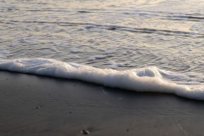 High angle view of waves rushing towards shore