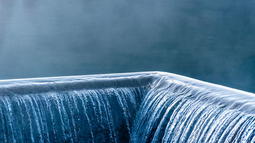 Close-up of metal ring in blue water