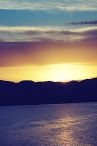Scenic view of sea against romantic sky at sunset