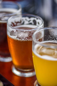 Close-up of beer glasses on table