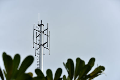 Low angle view of communications tower against clear sky