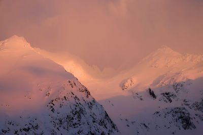 Scenic view of snowcapped mountains against sky during sunset