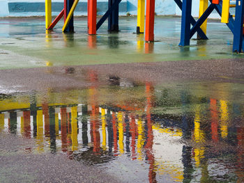 Reflection of building in puddle during rainy season