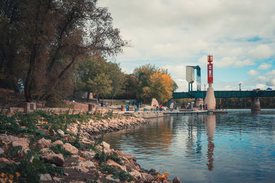 Trees by water against sky