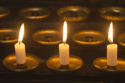 High angle close-up of candles burning