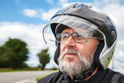 Close-up of man in helmet looking away