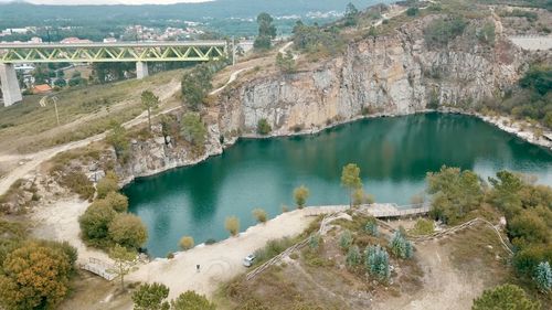 Scenic view of river by mountains against sky