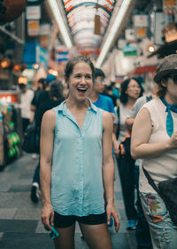 Portrait of smiling young woman in city