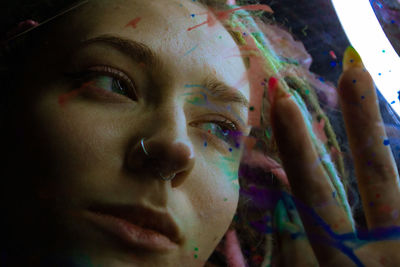 Close-up of young woman with paint colors
