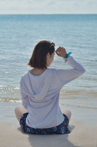 Rear view of woman looking at sea