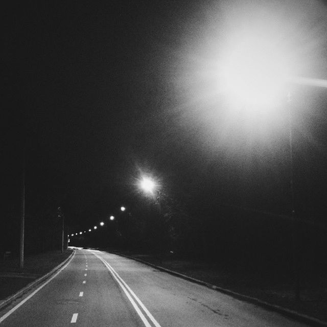 the way forward, transportation, diminishing perspective, road, road marking, vanishing point, illuminated, street, empty road, night, street light, empty, long, sky, outdoors, asphalt, no people, copy space, lighting equipment, mode of transport