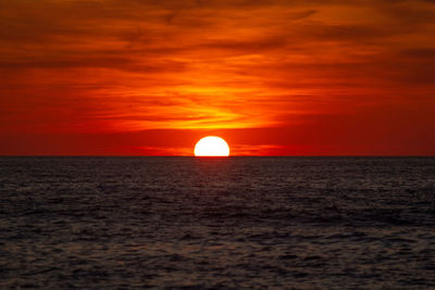 Scenic view of sea against romantic sky at sunset