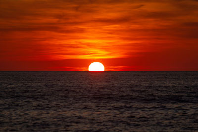 Scenic view of sea against romantic sky at sunset