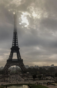 Eiffel tower against cloudy sky