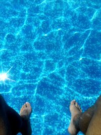 Low section of woman swimming in pool