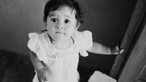 Portrait of cute girl standing at home