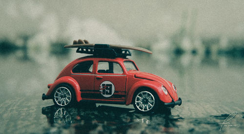 Toy car on road during rainy season