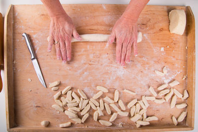 High angle view of human hand on cutting board