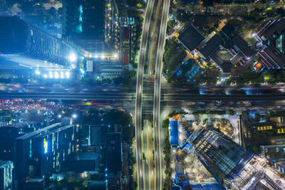 High angle view of illuminated buildings in city at night