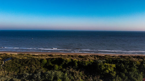 Scenic view of sea against clear blue sky