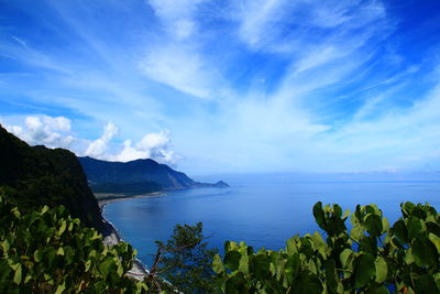 High angle view of blue sea by rocky shore