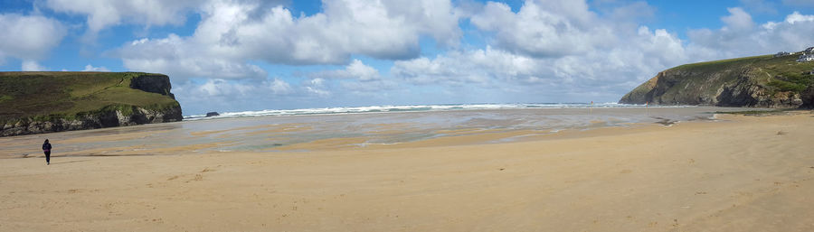 Panoramic view of beach against cloudy sky
