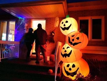 Group of people at illuminated market during halloween