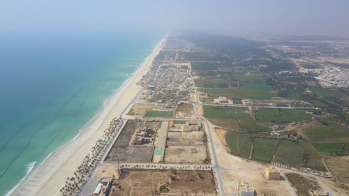 High angle view of land and sea against sky