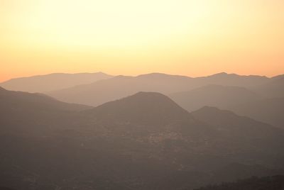 Silhouette mountains against clear sky at sunset
