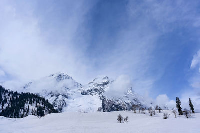 Scenic view of snow covered mountains against sky