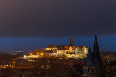 High angle view of illuminated buildings in city at night