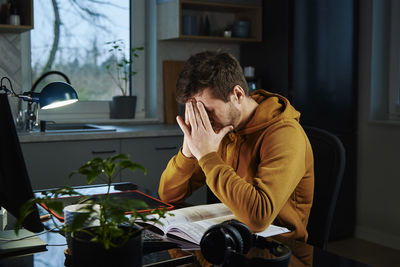 Man working late remotely at home