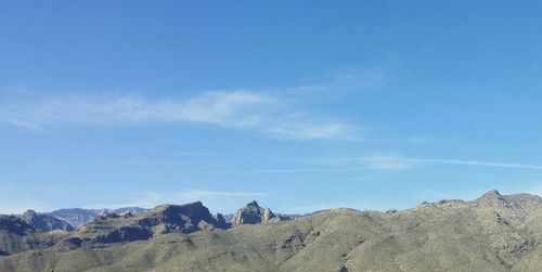 Scenic view of mountains against blue sky